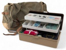 Cantilever tackle box holding variety of sea fishing leads, hooks, etc., and a traditional canvas