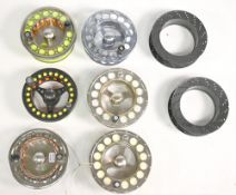 Six unnamed fly reel spare spools, in diameters 92mm-100mm, five with lines, two Scierra zip foam
