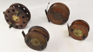 A collection of mahogany and brass star back reels. All with twin handles and slater style