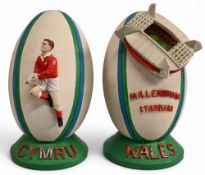 Pair of Large Heavy Ceramic Welsh Rugby Ball shaped figures (2): One with model of the Millennium/