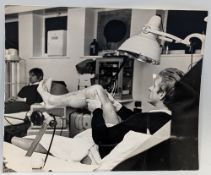 1967/68 b&w press photograph 21cm v 18cm of Denis Law on the treatment table at Old Trafford, it