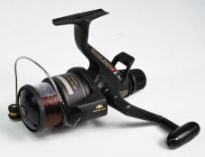 Shimano 6010 XT-7 Aero Baitrunner spinning reel with full bail arm, rear adjuster, appears in