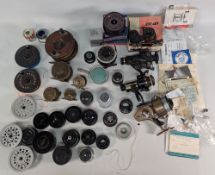Fishing Reel Graveyard: assorted reels, spools, boxes and instructions, some complete some parts
