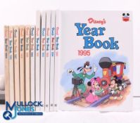 12x Disney's Year Books - 1984, 1986-1995 in fair-good condition, the 1984-1990 editions have marked