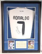 Signed and framed Cristiano Ronaldo Real Madrid football shirt and two colour photographs;