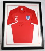 Rio Ferdinand Signed Red England Umbro Shirt, well framed and mounted under Perspex - size #74cm