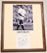 G Chilcott Signed Mounted Pic: 12” x 10” b/w action shot of ‘Coochie’ in England kit, signature laid