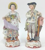 A pair of figures depicting a man and woman in 18th century dress, floral motifs, slashed notch mark
