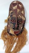 Eleven African Masks, to include a double headed totem style carved mask, a painted woven mask