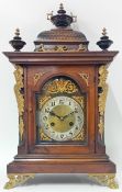 A late 19th century German mantle clock, maker J Unghans, of architectural form with an urn finial