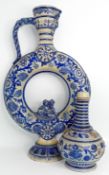A German Westerwald salt-glaze circular jug, blue and cream raised floral decoration, a face below