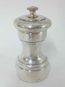 A silver pepper mill, stamped 'sterling', height approx 9.5cm.