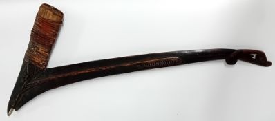 An Oceanic ceremonial axe haft, from Massim region of Southern Papua New Guinea, of carved wood