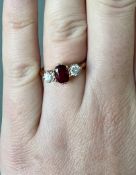 An 18ct yellow gold ruby and diamond three stone ring, stamped PLAT, size J/K.