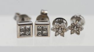 Two pairs of diamond earring studs.