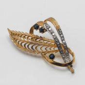 A stylish yellow metal brooch set with gem stones with indistinct hallmark, approx 6g