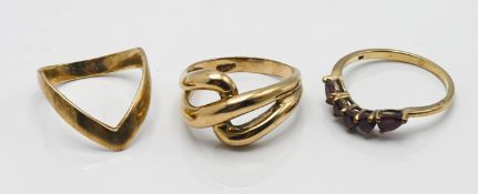 A 9ct gold wishbone style ring, a 9ct gold twisted style ring together with a 9ct gold garnet set
