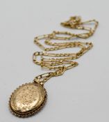 A 9ct gold oval engraved flower locket and chain, approx 5.6g