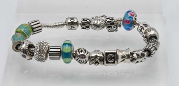 A silver pandora bracelet set with twenty charms (not all charms are Pandora).