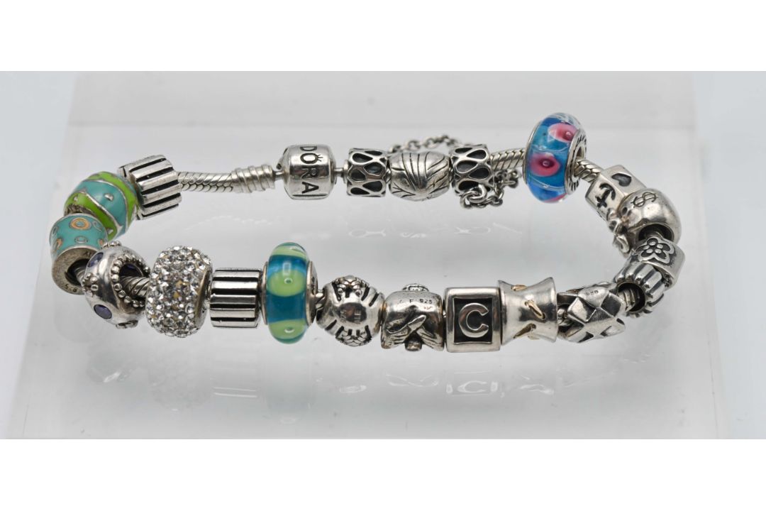 A silver pandora bracelet set with twenty charms (not all charms are Pandora).
