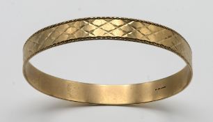 A 9ct gold bangle, with incised decoration, approx 15.9g.