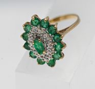 A 9ct yellow gold emerald and diamond cluster ring, size M.