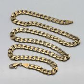 A 9ct gold flat faceted curb chain with lobster catch, approx 24.2g, length 52cm.