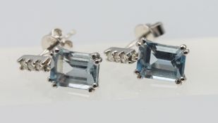 A pair of 18ct white gold aquamarine and diamond drop earrings, with rectangular cut aquamarine