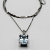 An 18ct white gold diamond and aquamarine drop pendant on a fine box chain.