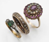 Three rings including a 9ct ruby and opal cluster ring, three stone emerald and diamond ring (not