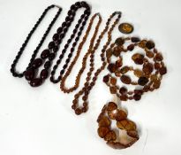 A collection of amber jewellery including a string of cherry amber necklace.