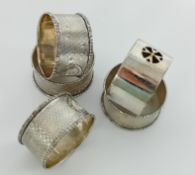 Four silver napkin rings, together with another, overall weight 3.47oz. (5)