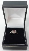 A ruby and diamond cluster ring, centre small round ruby surrounded by eight old cut diamonds 18ct
