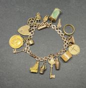 A 9ct gold charm bracelet set with fifteen charms and a George V 1912 gold sovereign (mounted), a