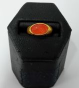 A Roman gold ring, formed from a round hoop with a D section and a bezel that secures a carnelian