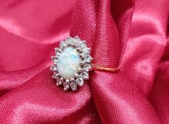 An 18ct yellow gold opal and diamond cluster set ring, approx 4.7g, size J.