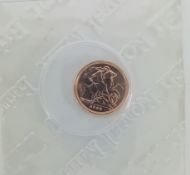 A 2009 gold proof quarter sovereign.