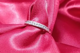 A platinum and diamond half eternity ring, approx 3g, size L/M.