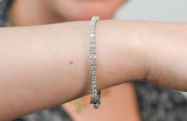 An 18ct white gold diamond line bracelet, set with forty nine diamonds, total diamond weight 7.19ct,