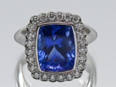 A fine 18ct white gold diamond and tanzanite ring, with rub over setting, tanzanite weight 6.72ct,