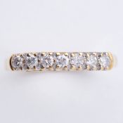 An 18ct yellow half eternity style ring set with seven round brilliant cut diamonds, total weight