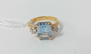 An 18ct yellow gold diamond and aquamarine set ring, size M.