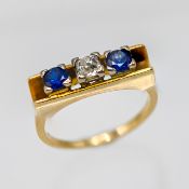 A diamond and sapphire three stone ring (not hallmarked), approx 5.8g, size P.