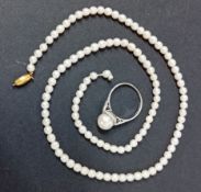 A 9ct white gold diamond and pearl ring, approx 2.6g together with a single row of pearls with 9ct