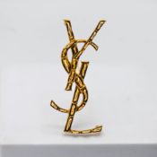 A YSL (Yves Saint Laurent) brooch, with booklet, dust cover, receipt, box.