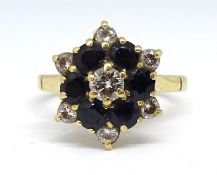 An 18ct sapphire and diamond cluster ring, set with a 4mm white diamond centre stone surrounded by