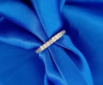 A platinum (unmarked) diamond half eternity ring, size L.