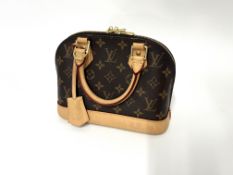 Louis Vuitton, a small Alma BB monogram handbag, date code FL4220, with Louis Vuitton padlock,