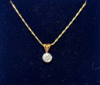 An 18ct yellow gold single stone diamond pendant on a 18ct yellow gold chain.
