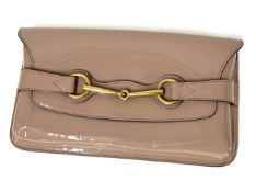 Gucci, a nude colour patent leather clutch bag, Gucci tag number H014606045, with small booklet,